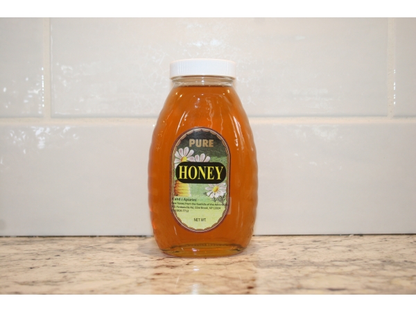 K and J Apiaries Liquid Raw Honey packaged in a 1 lb Classic Jar
