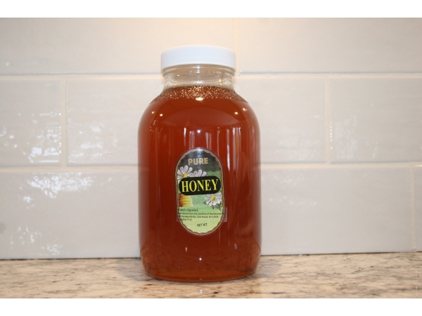 K and J Apiaries Liquid Raw Honey packaged in a 5 lb Classic Jar