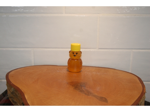 K and J Apiaries Liquid Raw Honey Bear in a 2 ounce squeeze bottle
