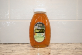 K and J Apiaries Liquid Raw Honey packaged in a 1 lb Classic Jar